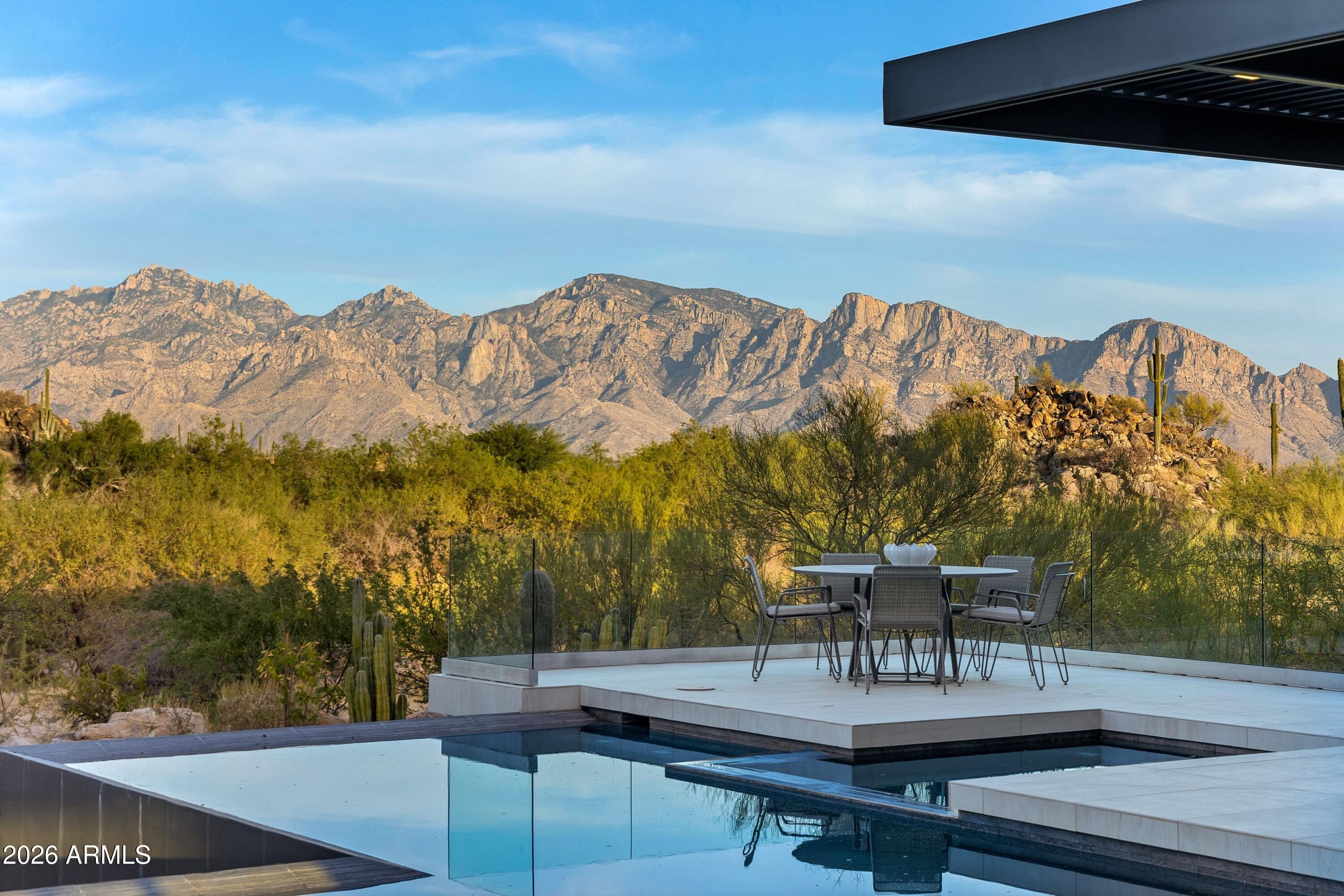 Luxury estate interior — floor-to-ceiling windows with mountain views